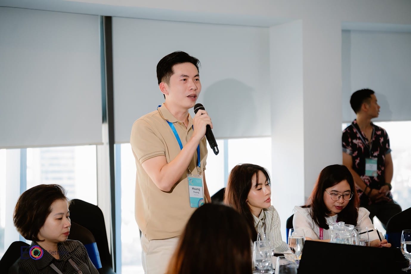 An EO Vietnam member speaking into a microphone during a chapter session