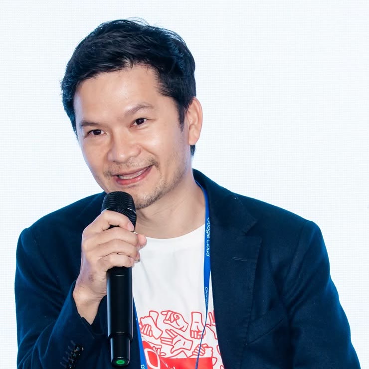 Hoang Truong smiling, speaking into a microphone