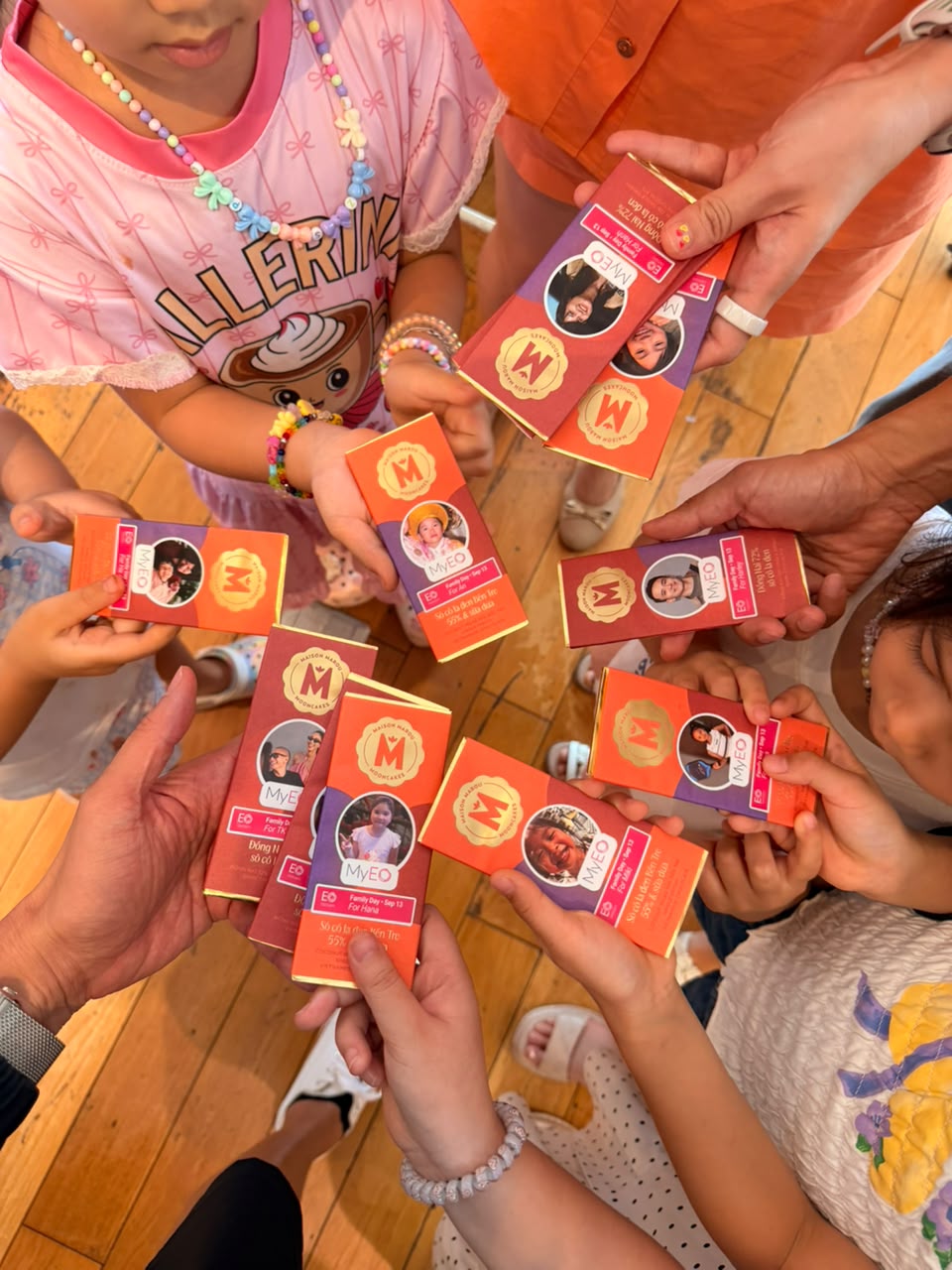 Attendees holding up their personalized Marou chocolate bars in a circle